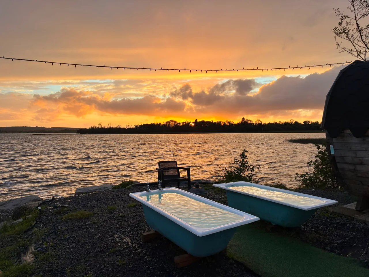 The blue baths catch the reflection of an orange sunset