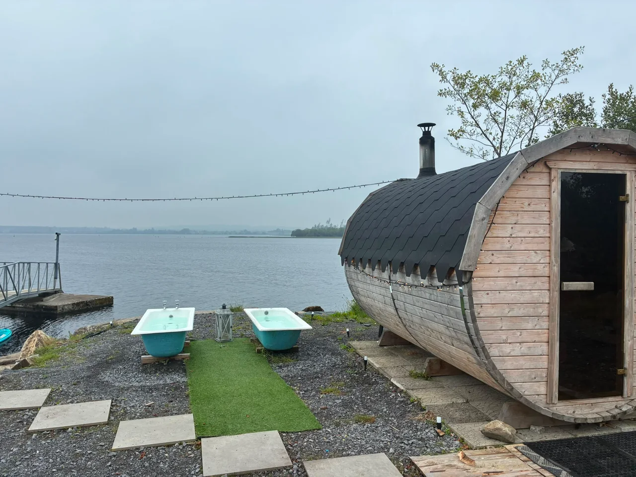 The sauna and blue plunge baths on a misty day at the lake